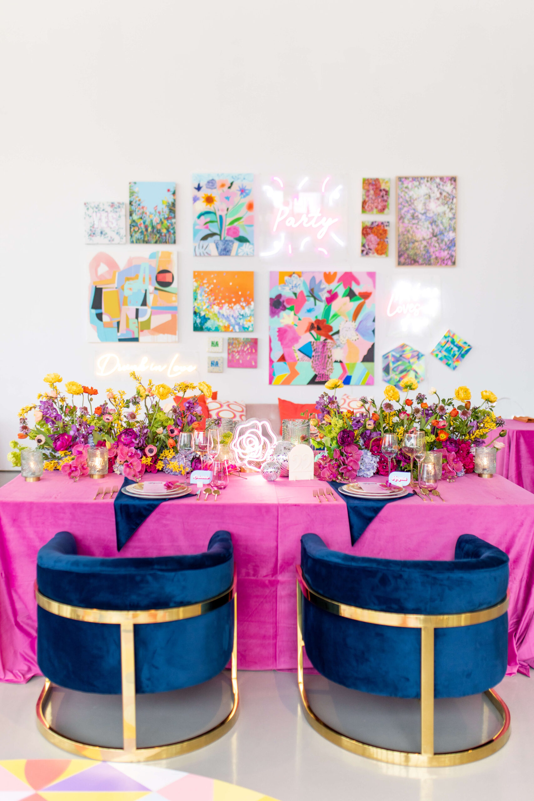 Bright and colourful art gallery wall behind a disco inspired tablescape